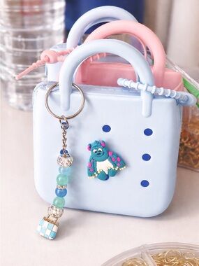 Blue Mini wallet tote with charm and sulley accent.